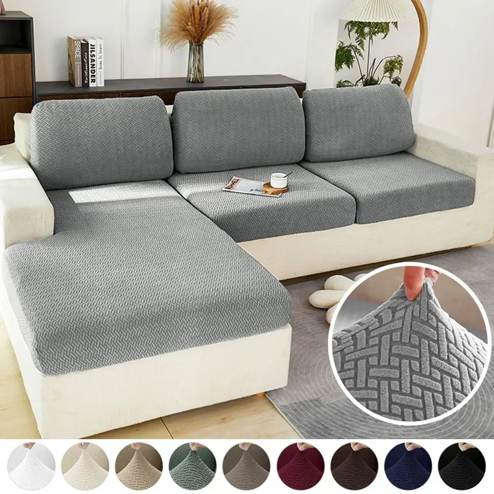 Gray herringbone-patterned stretch sofa cover protecting living room furniture with elastic fabric for a snug fit