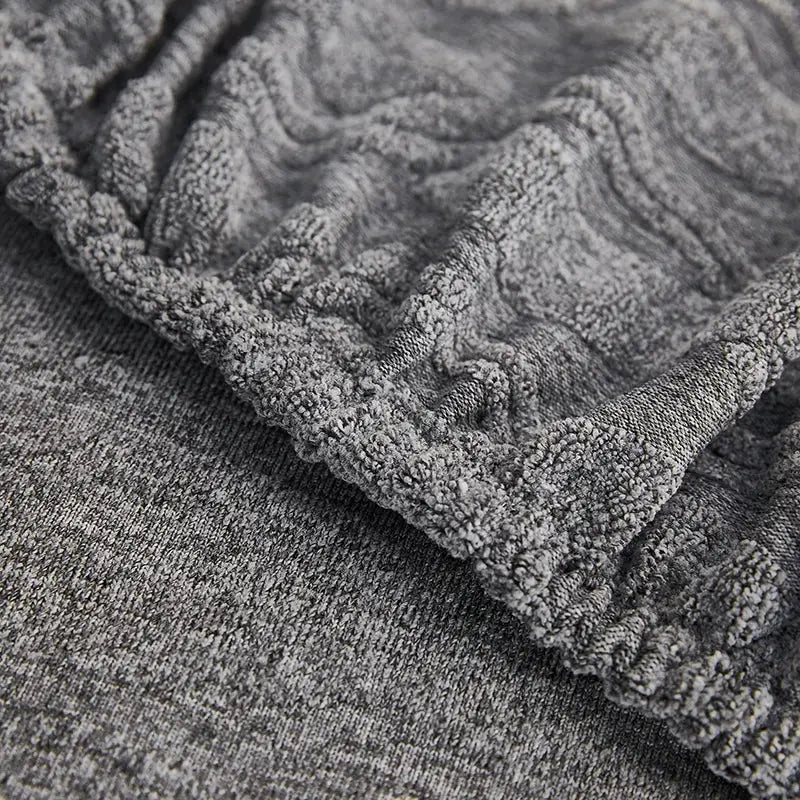 Gray jacquard sofa seat cover with plush gray textured cable-knit fabric for living room furniture protector decorbites