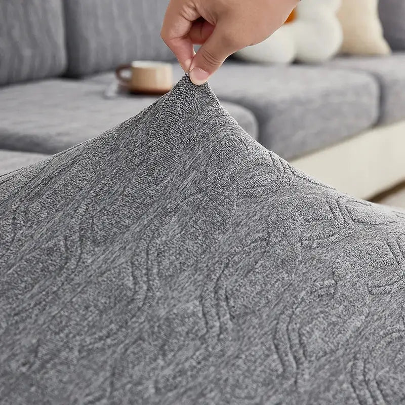 Gray jacquard sofa seat cover with subtle woven pattern made of textured fabric for living room furniture protection decorbites jacquard sofa cover