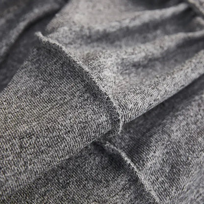 A soft heather gray decorbites jacquard sofa cover with textured weave and frayed edge for living room furniture protection