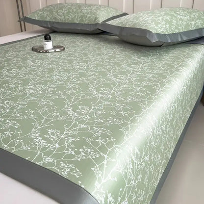 A sleek light green bed mat set with white branch blossom pattern and gray border for bedroom cooling mattress use