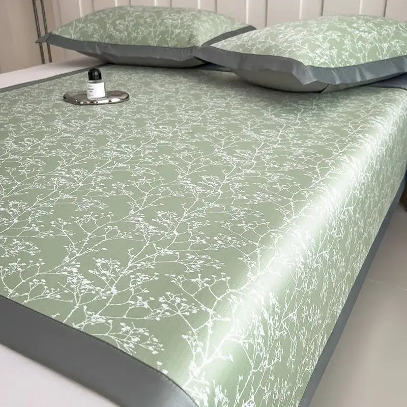 A sleek light green bed mat set with white branch blossom pattern and gray border for bedroom cooling mattress use