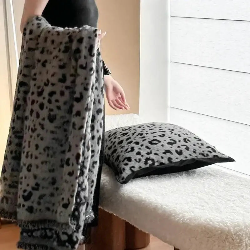 A plush gray and black leopard print luxury mink fur throw blanket with fringed edges perfect for bedroom decorbites decor