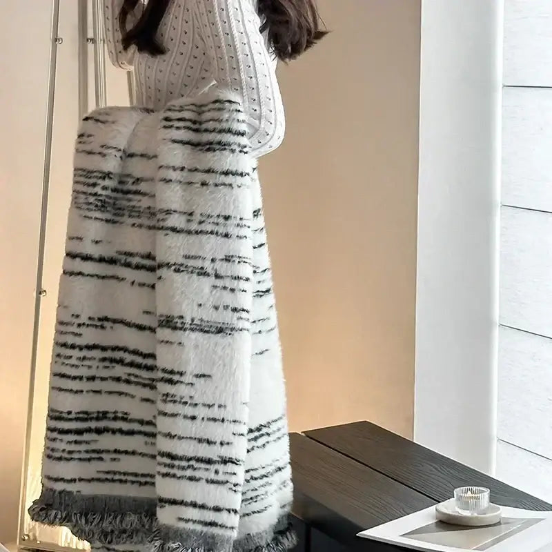 A cozy long white and black striped knit skirt with frayed hem paired with a gray leopard print luxury mink fur blanket decorbites leopard print