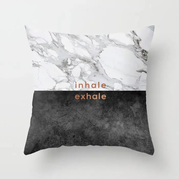 A square pillow case with gray marble top half, black agate bottom, copper inhale exhale text for living room decor
