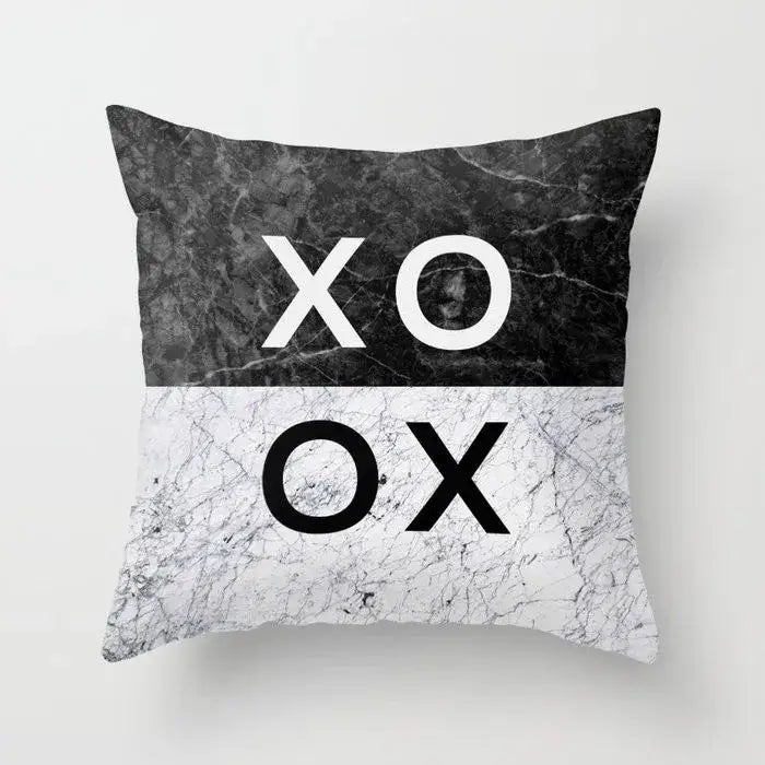Black and white marble-patterned throw pillow case with bold xo ox design in gray marble and black agate for living room decor