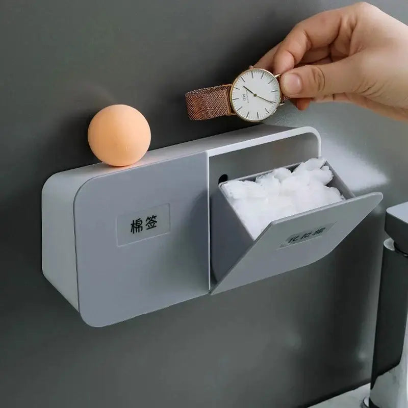 Gray wall-mounted dual-compartment decorbites cotton swab holder with labeled sections for cotton swabs and facial tissues