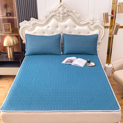 Blue quilted bed pad with subtle wavy texture and white border in decorbites cooling latex summer mat set