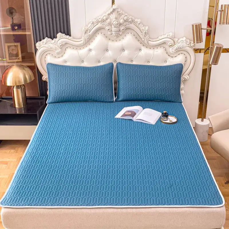 Blue quilted bed pad with subtle wavy texture and white border in decorbites cooling latex summer mat set