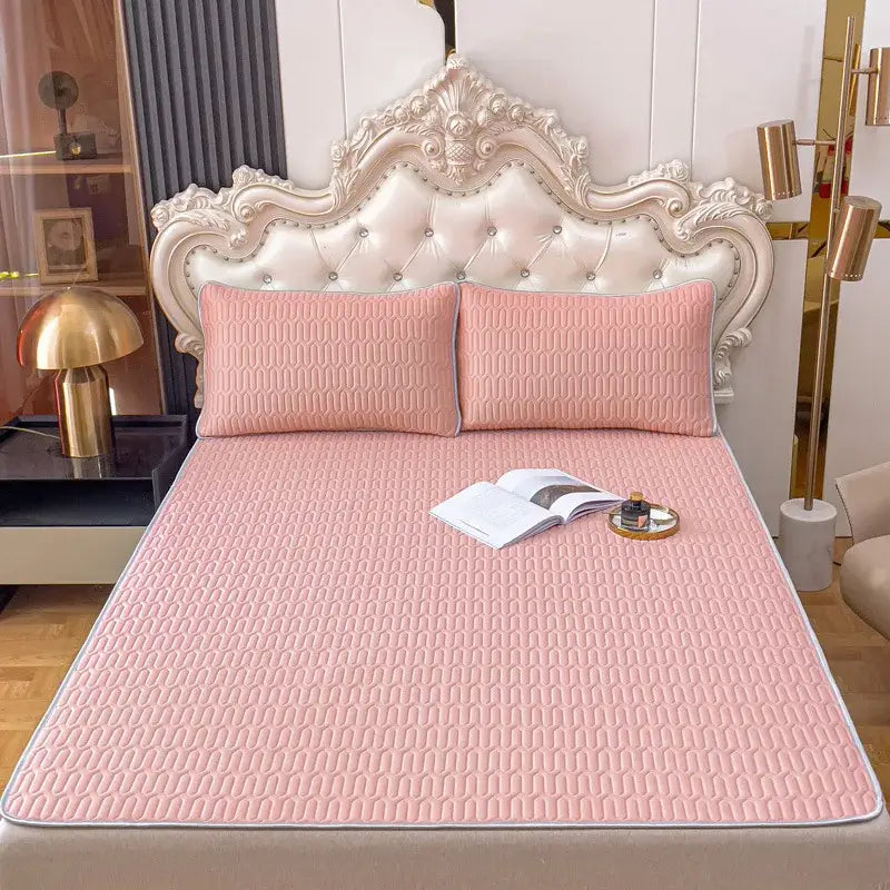 Pink quilted bed pad with subtle geometric pattern and stitched edges in gray quilted decorbites cooling latex summer mat set