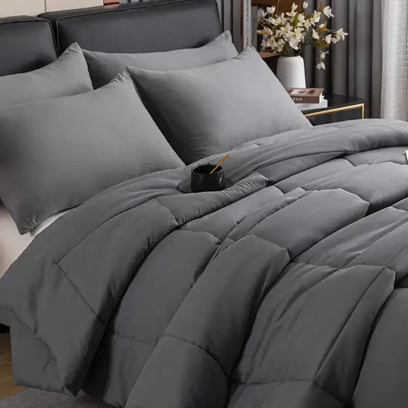 Gray king size quilted comforter with soft plush texture and subtle stitching patterns for bedroom use