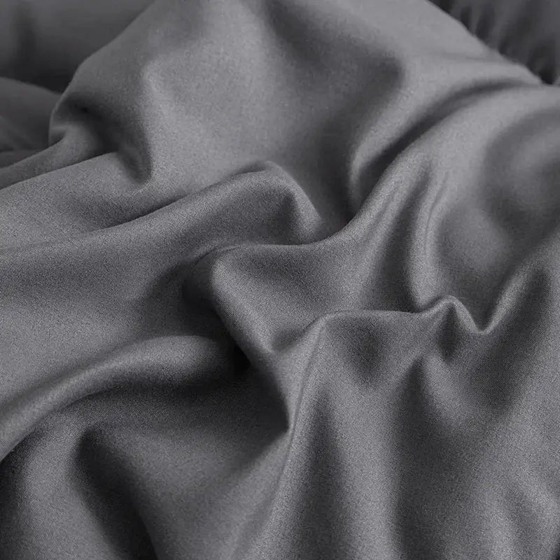 Soft dark gray satin-like king size quilted comforter with smooth texture and subtle sheen for bedroom use