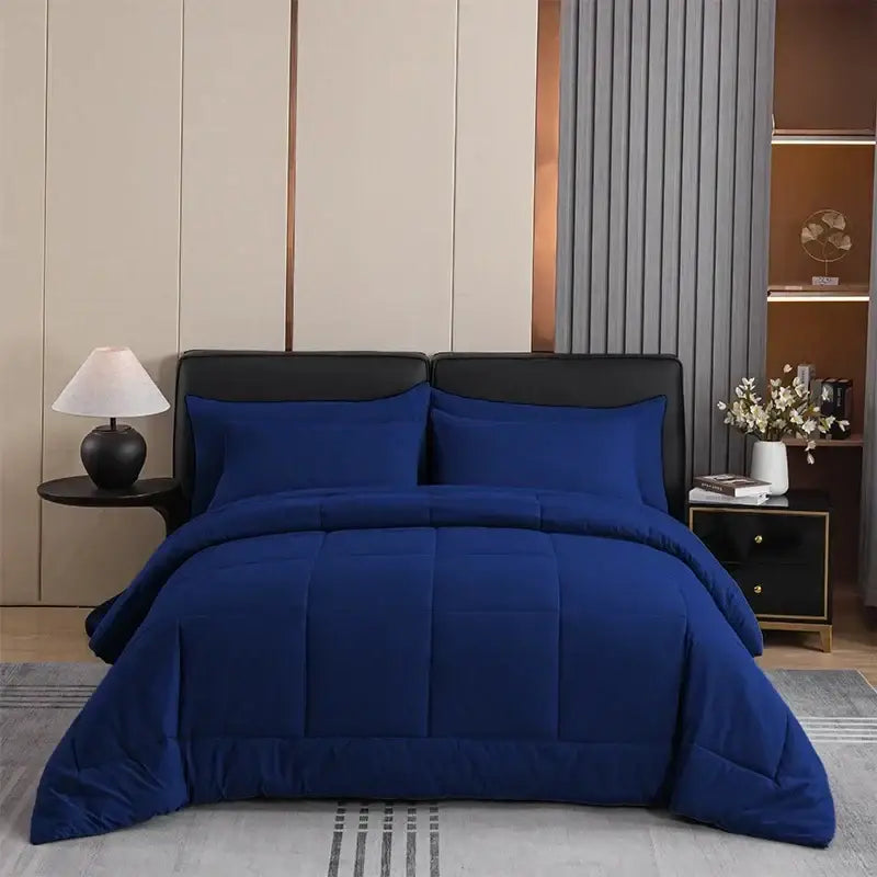 Royal blue king size quilted comforter set with plush fabric and matching pillows featuring clean stitched panels