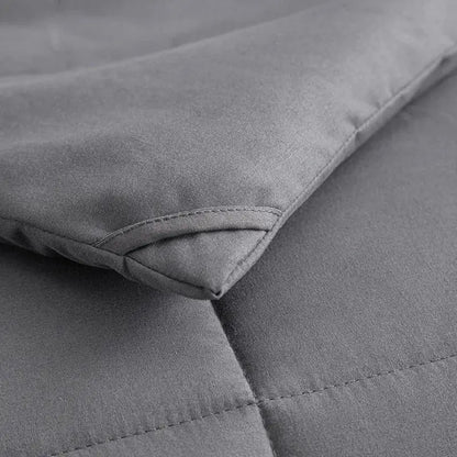 Gray king size quilted comforter with soft textured fabric and neat stitching for a plush bedroom blanket