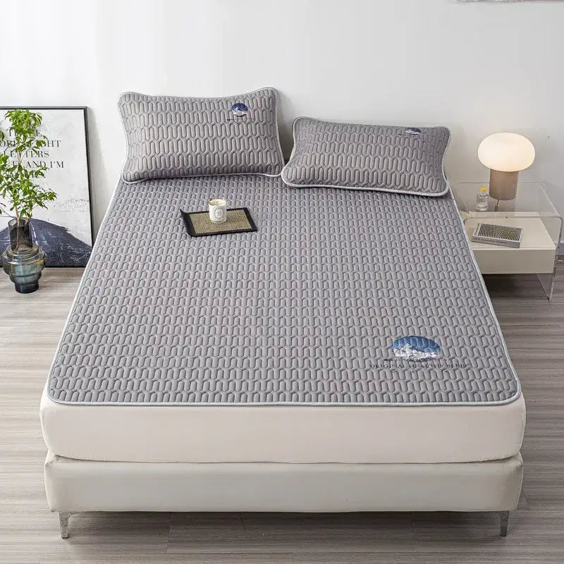 Gray quilted latex bed mat set with subtle texture and blue wave cloud embroidery for bedroom mattress protection