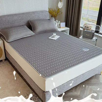 Gray quilted latex bed mat set with cooling mattress pad featuring subtle geometric pattern and stitched edges