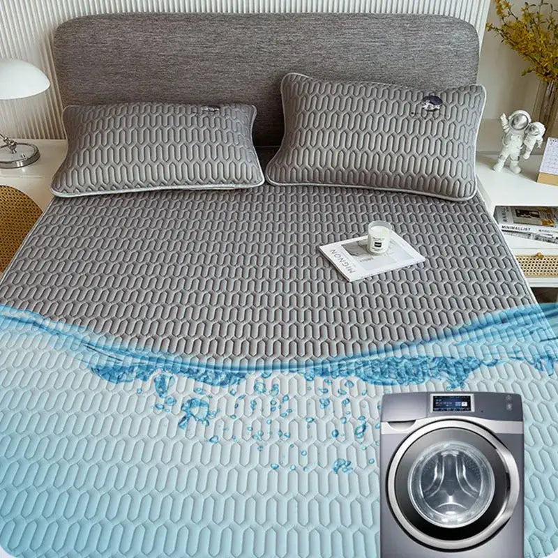 Gray quilted latex bed mat set with embossed hexagonal pattern and light blue water-resistant lower section