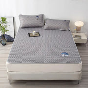 Gray quilted latex bed mat set with subtle textured pattern and small embroidered cloud motifs for bedroom use