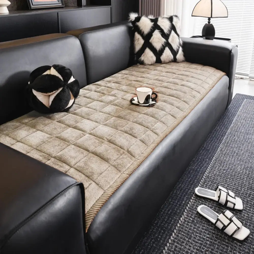 Beige quilted sofa towel cushion with diamond-stitched texture and braided edge for living room use