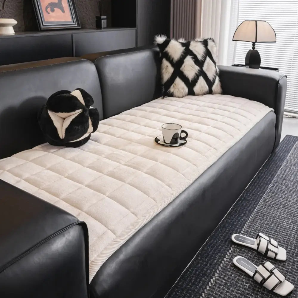 Cream-colored quilted sofa towel cushion with soft plush texture and subtle stitched pattern for living room use