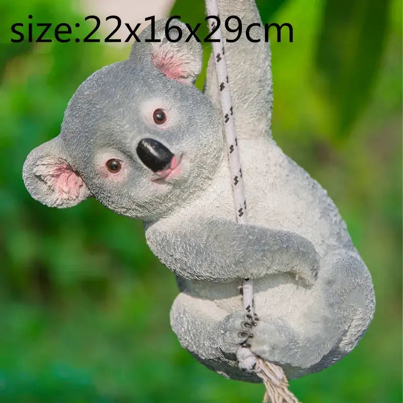 Gray resin cartoon koala garden sculpture with pink ears and black nose hanging from rope for outdoor decorbites decor