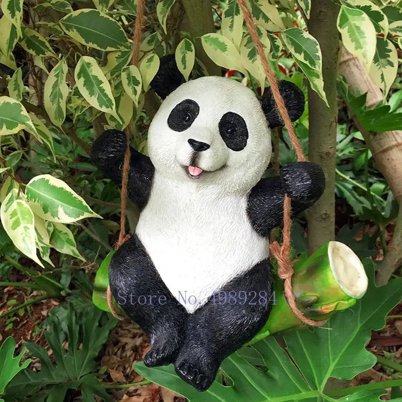 Adorable black and white panda garden sculpture hanging from twine on green bamboo stalk decorbites cartoon koala