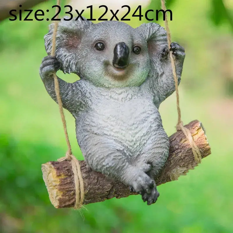 Gray resin cartoon koala garden sculpture hanging from rope on wooden log swing for outdoor decorbites cartoon koala