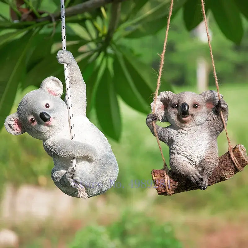 Gray resin cartoon koala garden sculpture featuring one swinging on a white rope and another seated on a branch decorbites cartoon koala