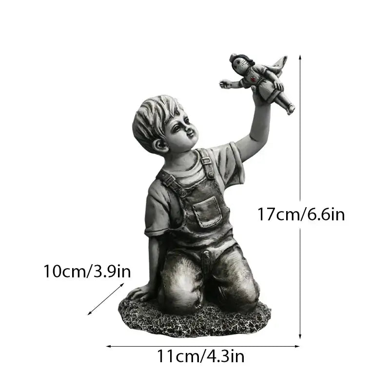 Gray resin super nurse angel boy statue of a kneeling boy in overalls holding a doll for living room decor