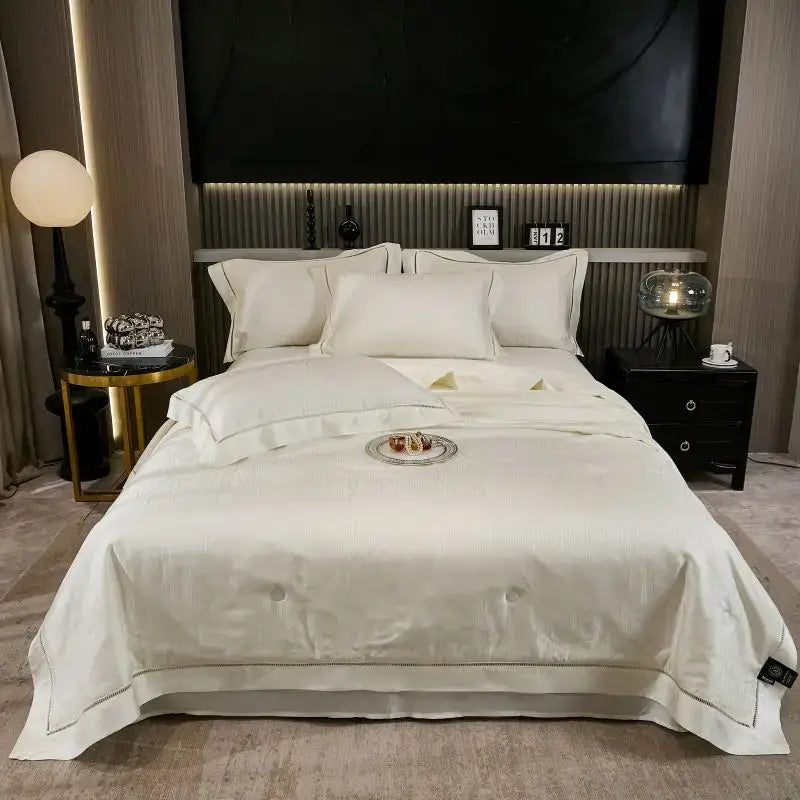 Cream-colored satin summer quilt set with elegant gold-threaded trim and subtle tufted design for bedroom bedding