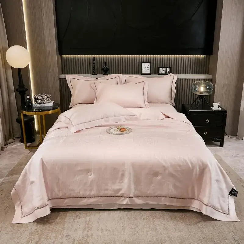 Pink satin summer quilt set with subtle embroidered trim and black trim for bedroom bedding use