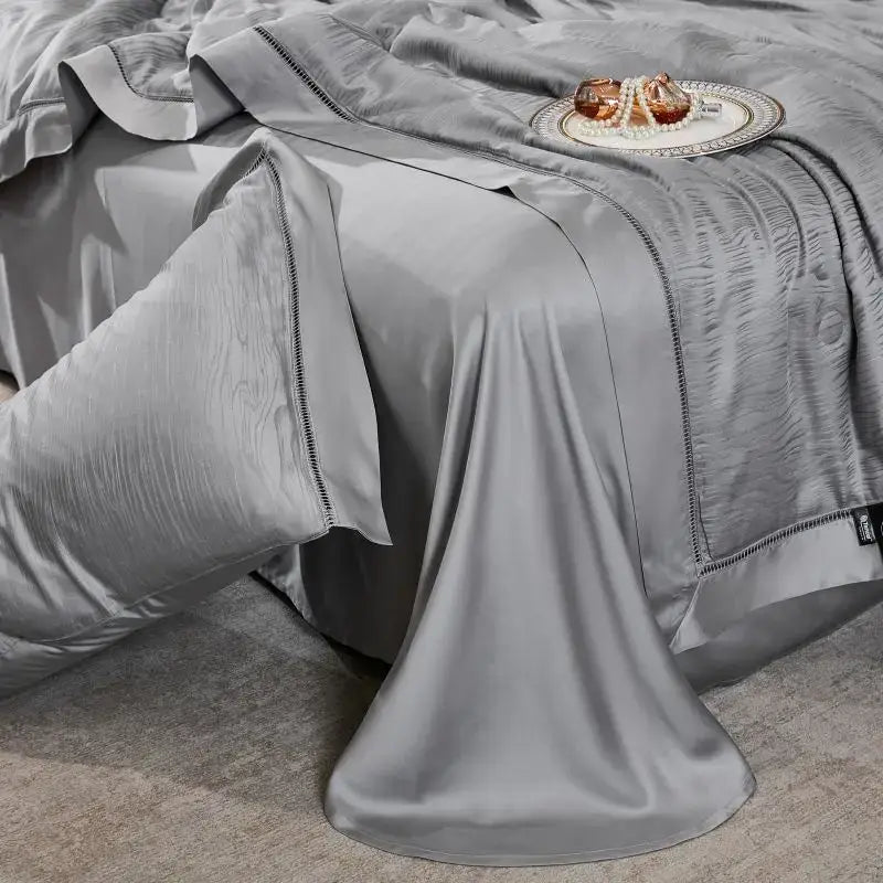 Silk-gray satin summer quilt set with elegant black stitched trim featuring ruched design for bedroom bedding