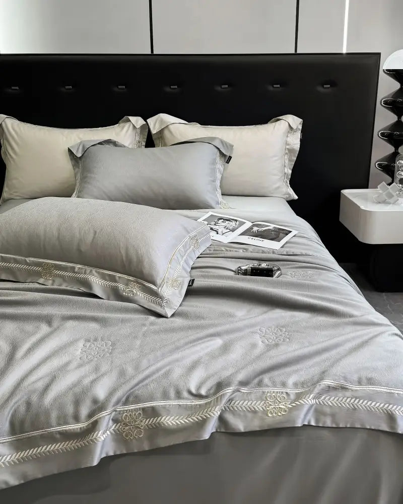 Gray satin eucalyptus fiber summer quilt bedding set with delicate gold trim embroidery for elegant bedroom decorbites