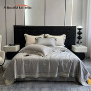 Gray satin eucalyptus fiber summer quilt bedding set with delicate gold embroidery trim for elegant bedroom decorbites
