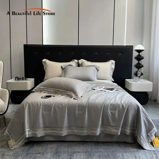 Gray satin eucalyptus fiber summer quilt bedding set with delicate gold embroidery trim for elegant bedroom decorbites