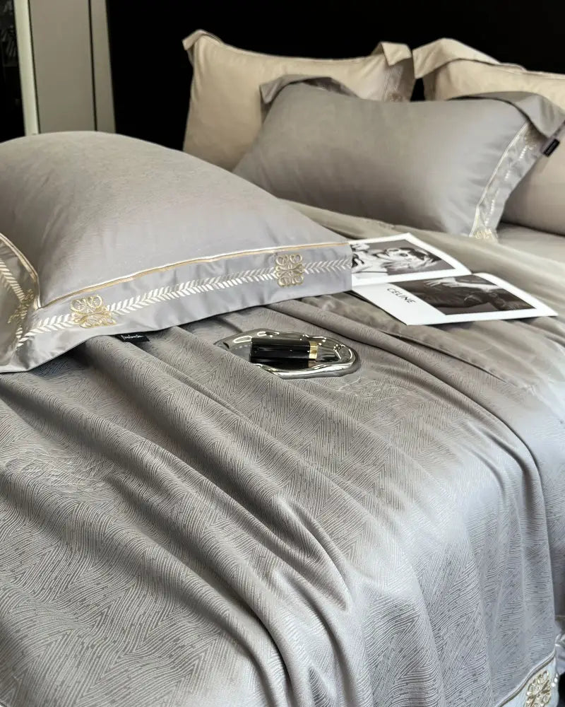 Gray satin eucalyptus fiber bedding set with gold-threaded embroidery and subtle texture summer quilt decorbites trim
