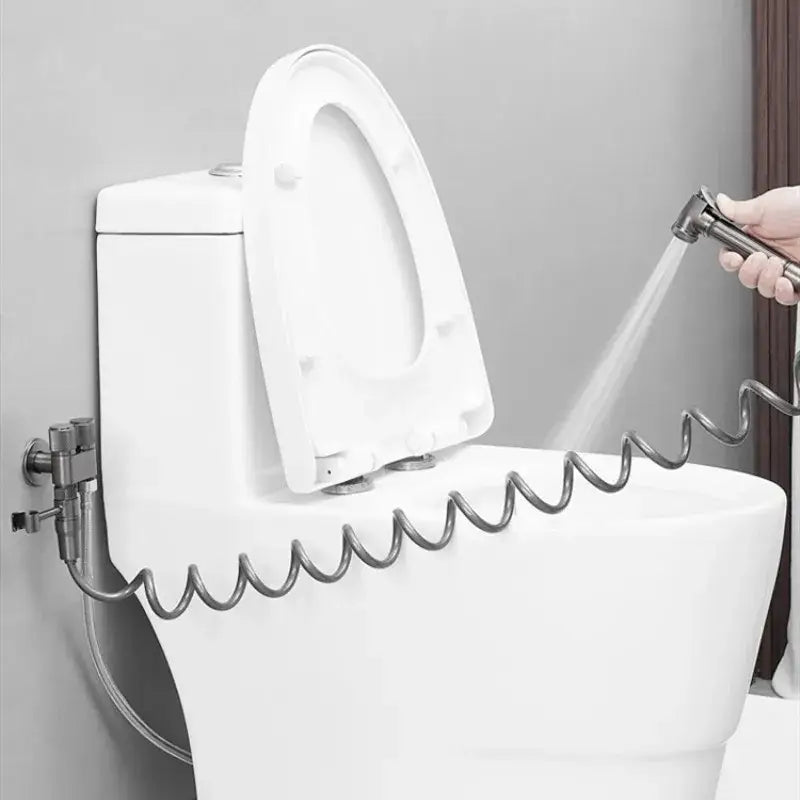 Gray stainless steel bidet faucet set with high pressure silver coiled hose and handheld spray nozzle attached to toilet