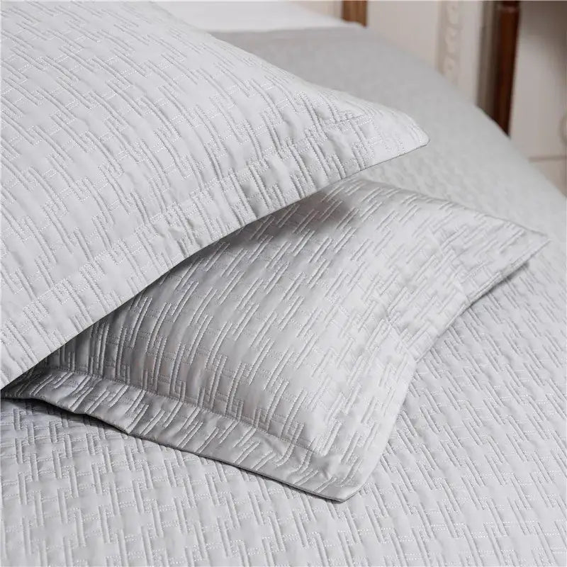 Light gray quilted pillowcases with subtle texture in a gray textured egyptian cotton quilt bedroom set
