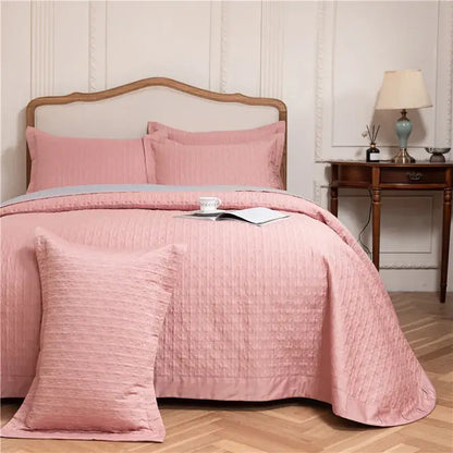 Pink textured egyptian cotton quilt set with matching pillows and subtle gray accent band reversible bedspread