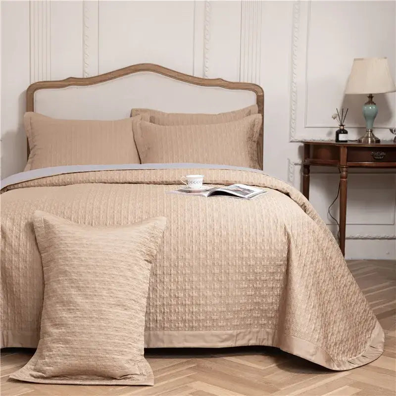 Beige quilted bedspread with subtle woven texture and matching pillows in gray textured egyptian cotton quilt set
