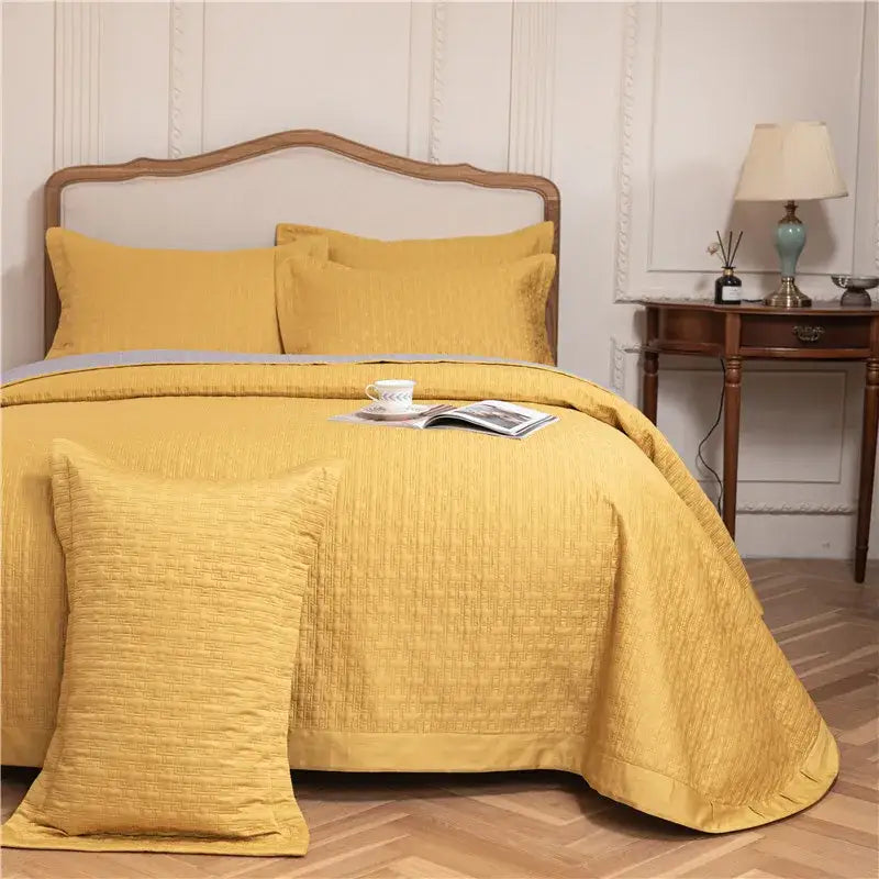 Yellow textured quilted bed set featuring a reversible gray textured egyptian cotton quilt for bedroom use
