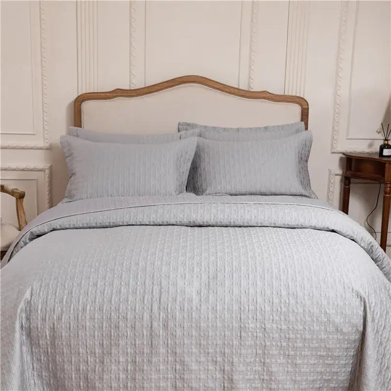 Light gray quilted cotton quilt set with subtle textured weave made from egyptian cotton for reversible bedding