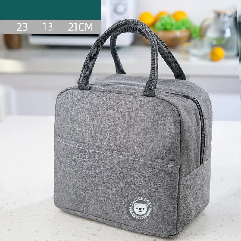 Gray textured insulated lunch bag with black leather handles and white embroidered bear logo for kitchen thermal use