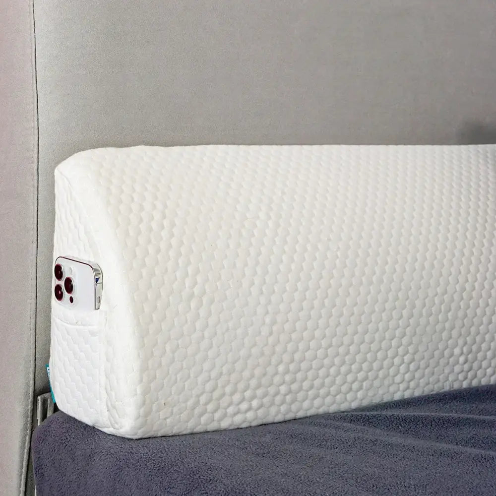 Gray memory foam bed wedge pillow with white honeycomb texture and built-in phone pocket for mattress gap filler