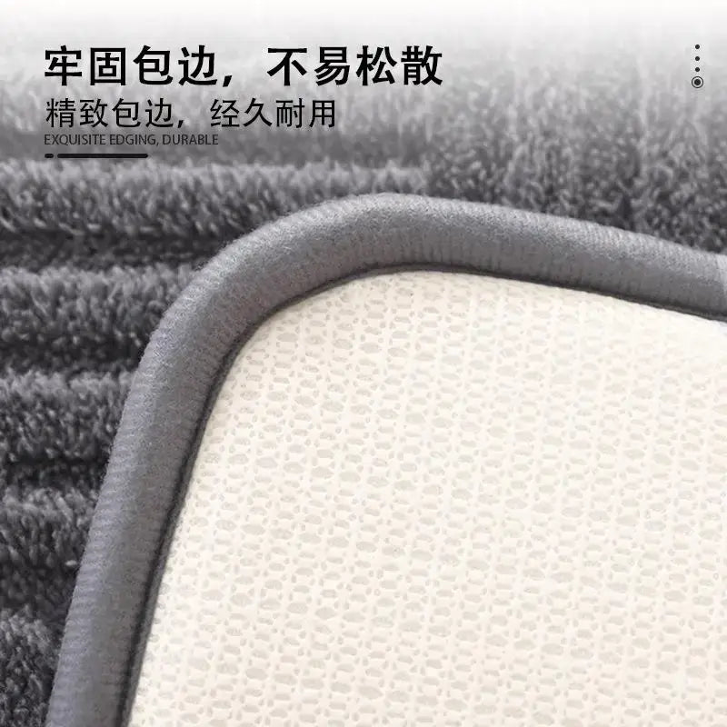 Gray plush striped floor mat with textured white mesh backing and reinforced durable edge for bathroom use