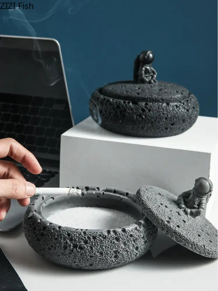 Gray volcanic stone cement astronaut ashtray with textured porous surface and matte finish for living room use
