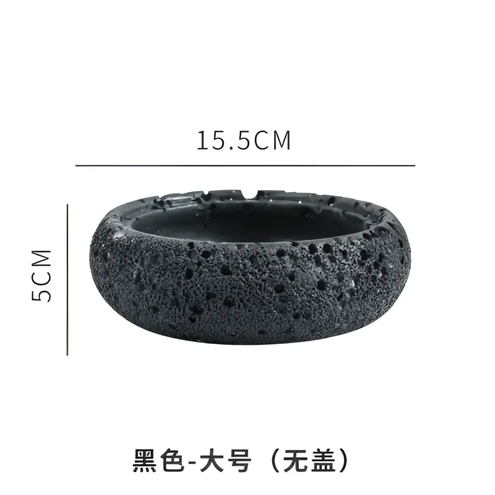 Gray volcanic stone cement astronaut ashtray in black lava rock with porous texture 15.5cm wide and 5cm high