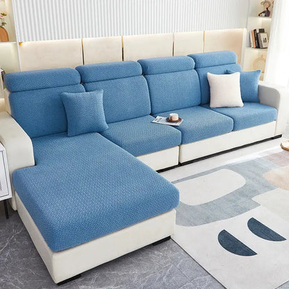 Blue textured decorbites jacquard velvet sofa cover with herringbone pattern snugly fitted over white sectional couch
