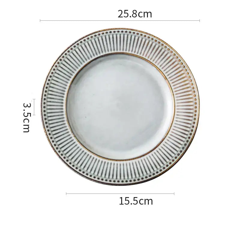 White ceramic plate with ribbed rim and gold accents from gray and white striped decorbites ceramic wedding tableware set