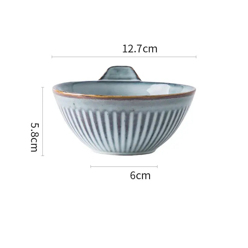 A light blue glazed ceramic bowl with vertical ridges and handle from gray and white striped ceramic wedding tableware set